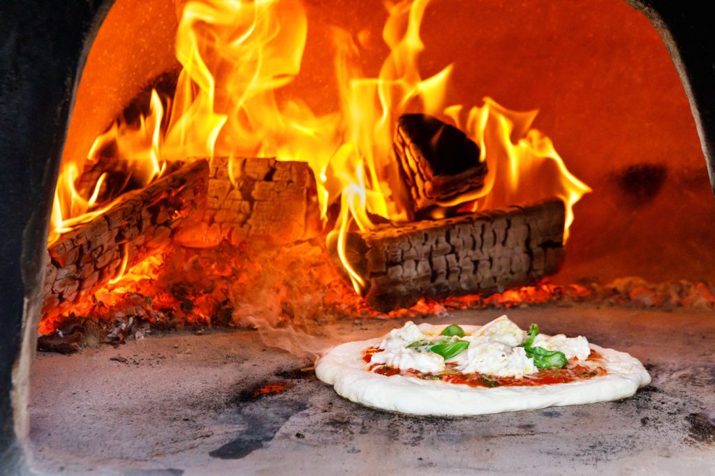 How to cook pizza in a wood-fired oven